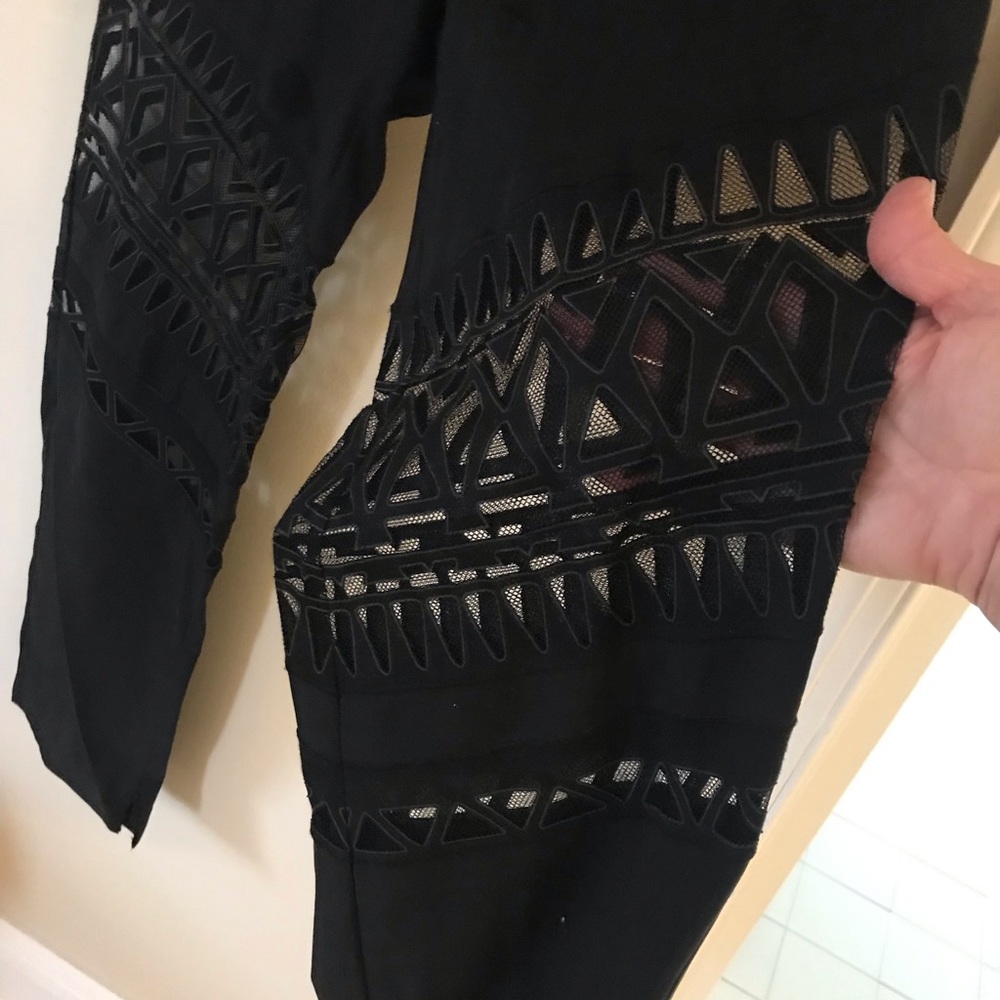 Black pant with see thu sections .